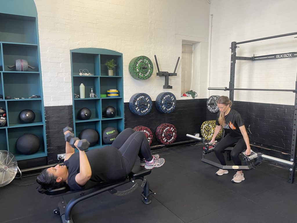 Two PT Club clients strength training during a small group session in Archway